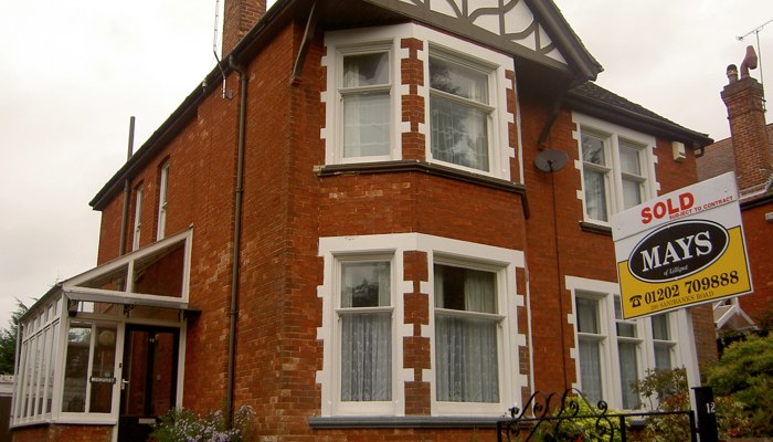 The house on Ormonde Road as bought, a redbrick semi with a SOLD sign at the gate