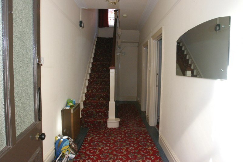 The original hallway, with patterned stair carpet, before any work began